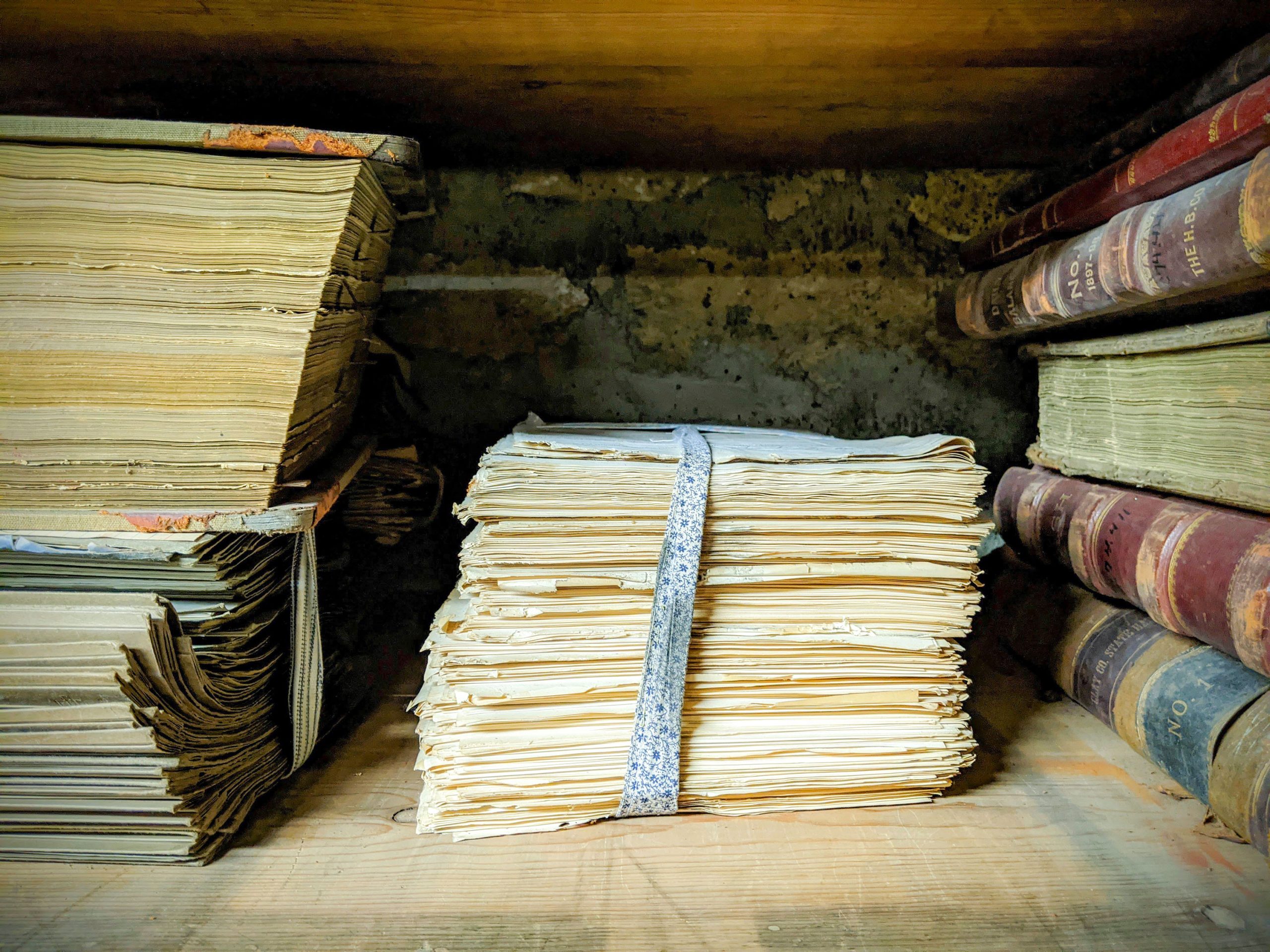 Old documents and books on a shelf