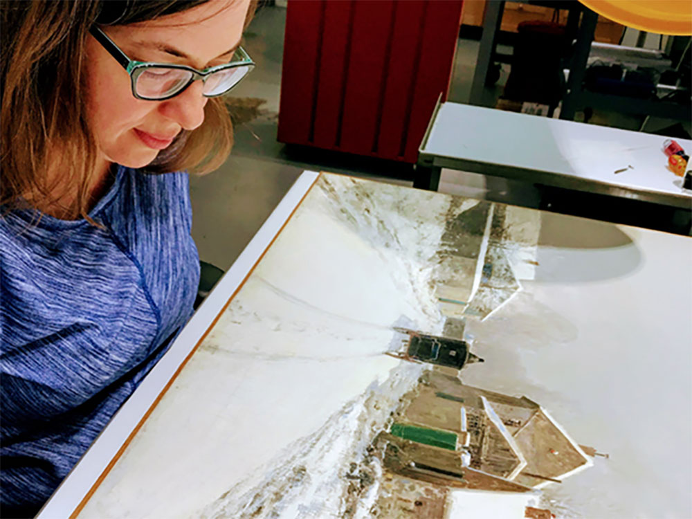 Kristy Jeffcoat examining a work of art