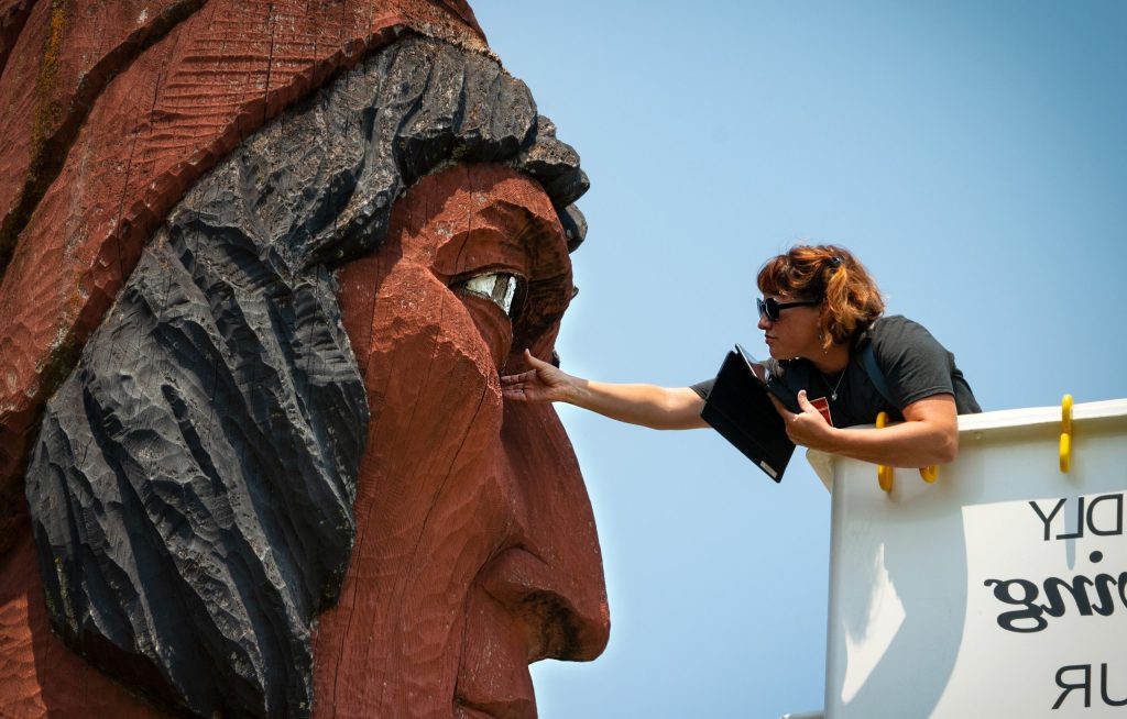 Megan Emery, Chief Conservator and Senior Objects Conservator, working on a large outdoor statue
