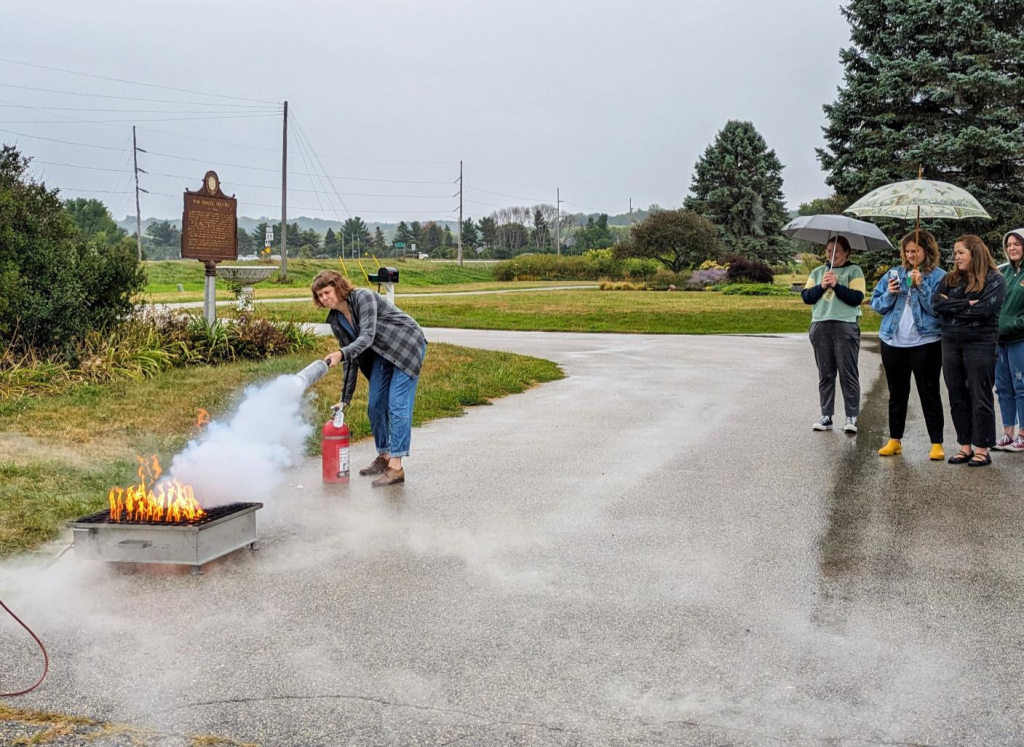 Preventive Conservator, Melissa Amundsen, demonstrating a fire extinguisher at a MACC Emergency Preparation workshop.