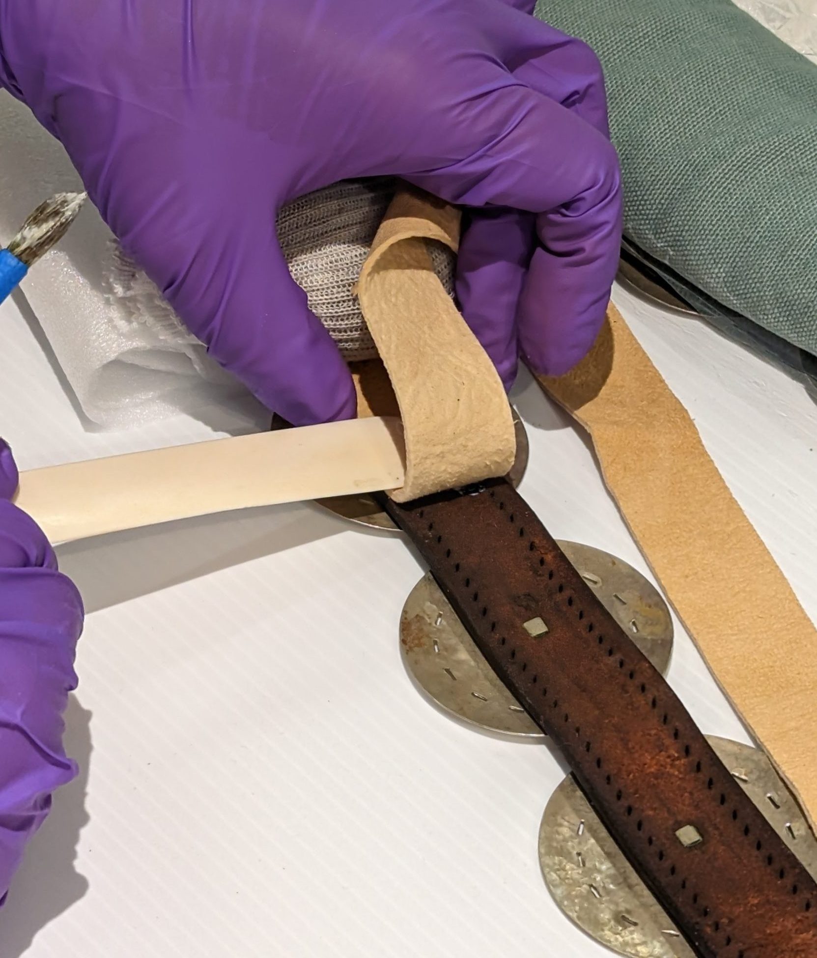A Conservator working on a repatriation treatment of a leather artifact.